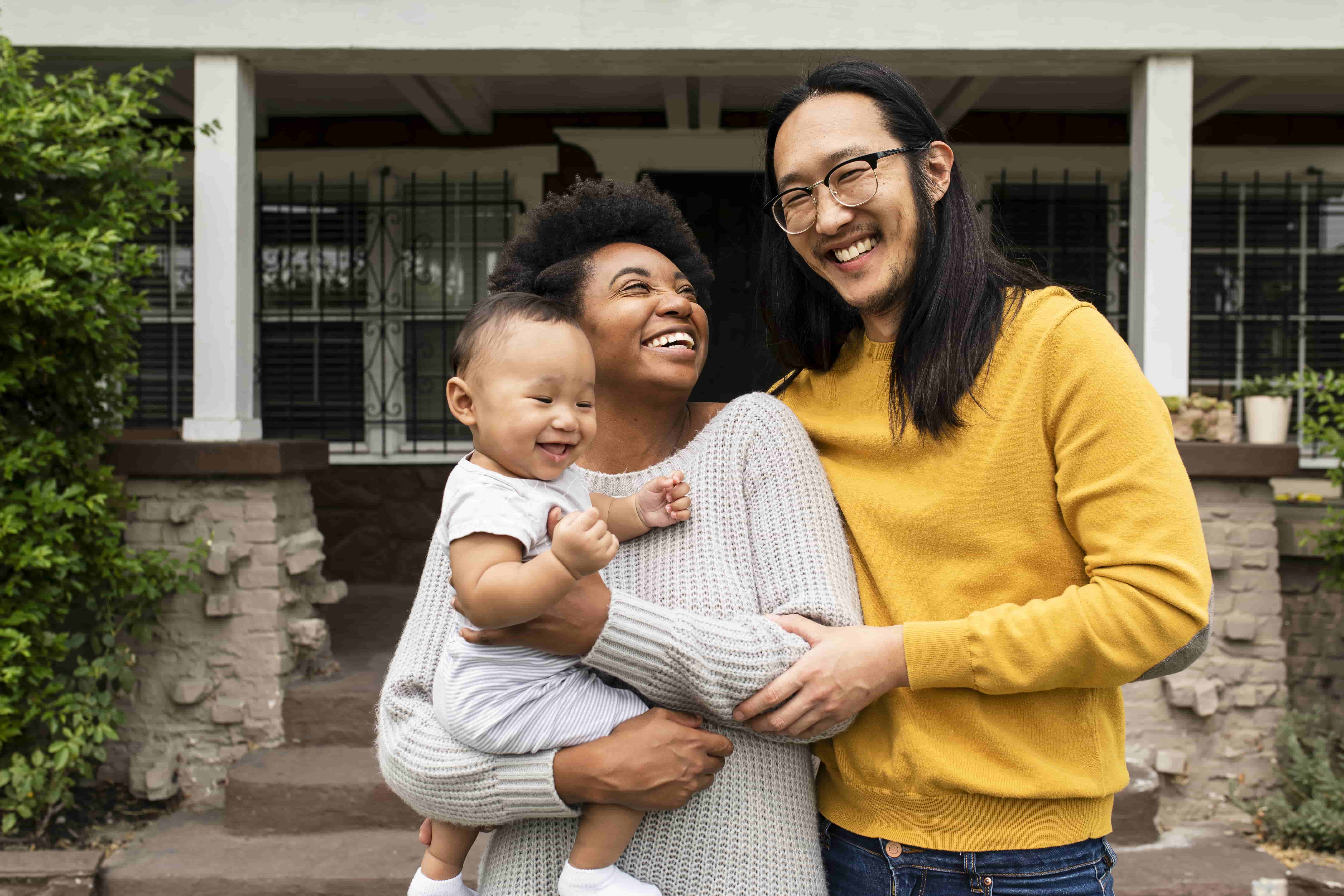 happy-multiethnic-family-standing-front-house-covid19-lockdown