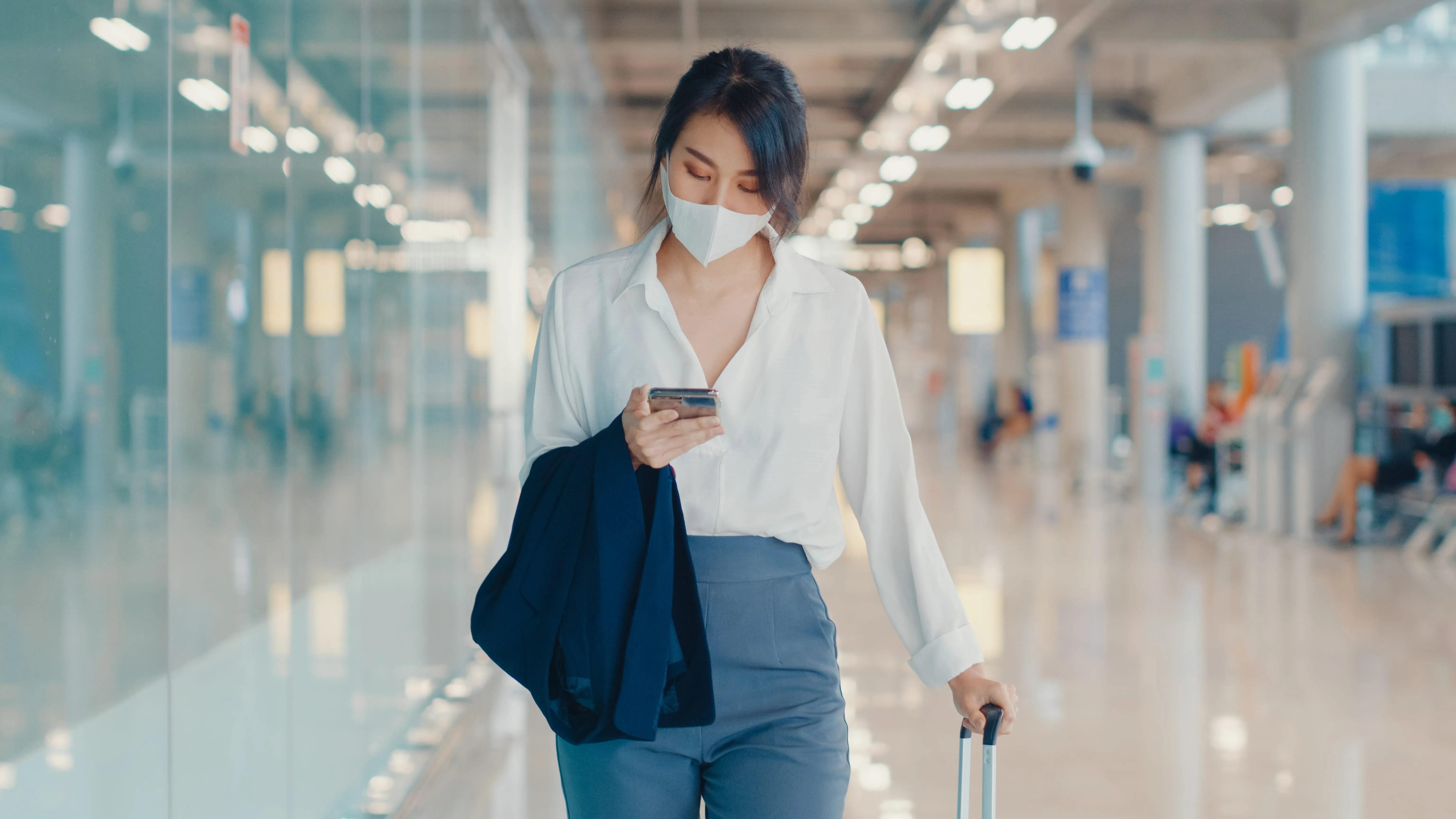 asian-business-girl-using-smartphone-check-boarding-pass-walking-with-luggage-terminal-domestic-flight-airport.jpg